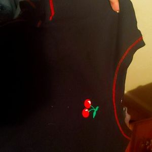 A black n red t-shirt that has a cherry on it